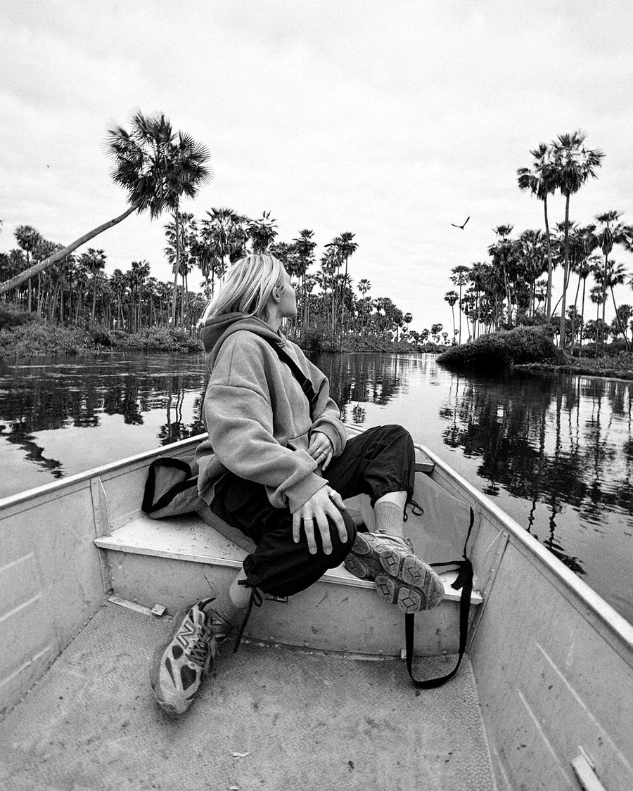 A traveler sitting in a small boat on a flooded palm wetland in Formosa, Argentina