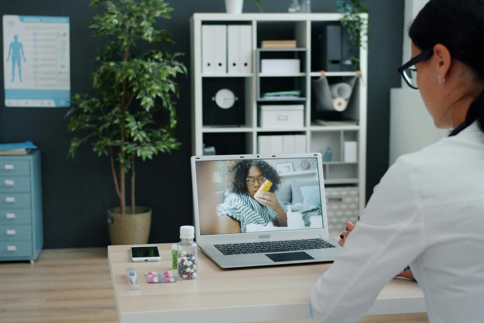 A doctor on a video call with a patient.