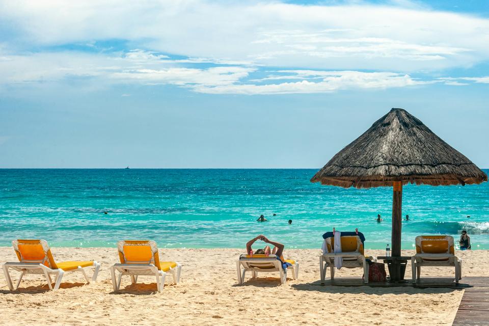 A palapa umbrella on a beach in Cancún.