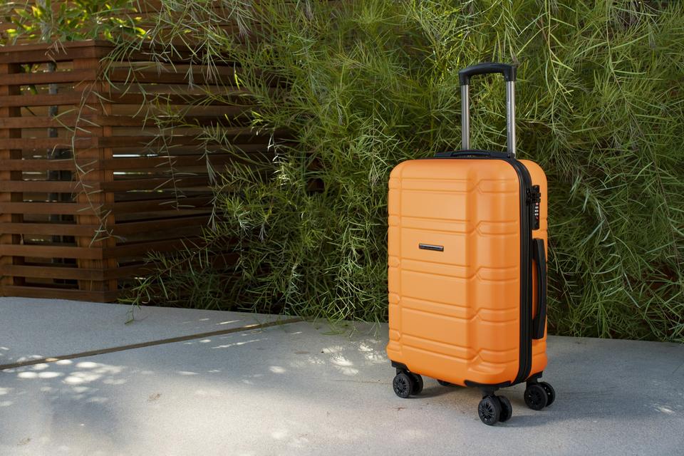 An orange carry-on suitcase.