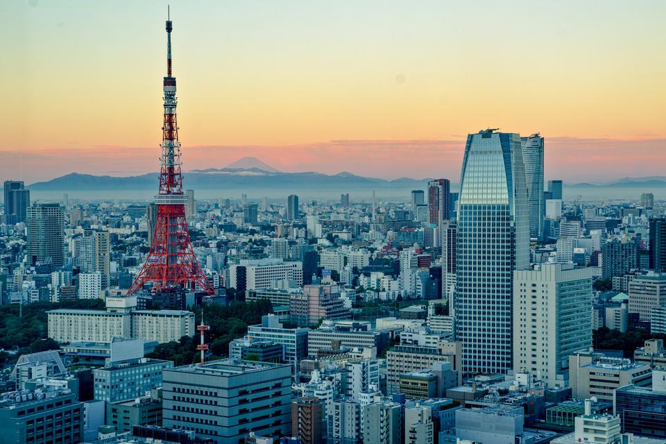 Tokyo Tower at dusk with Mount Fuji behind.