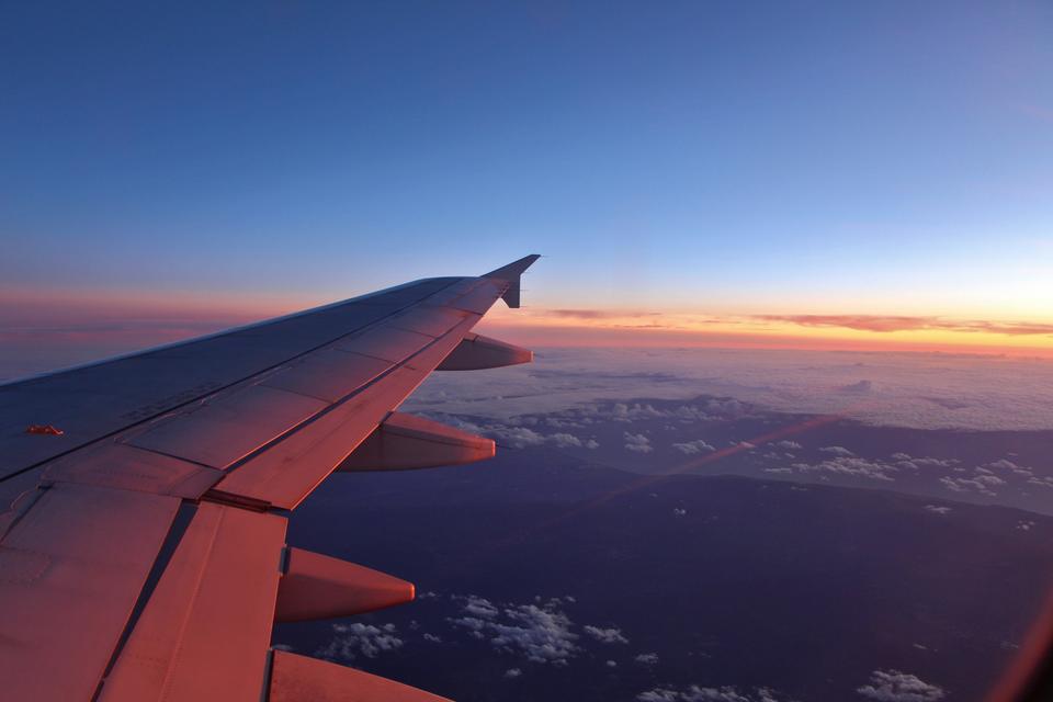 An airplane wing at sunset.
