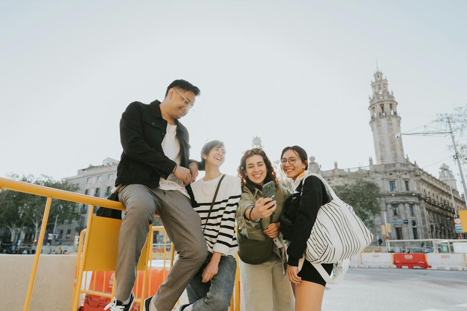 Friends talk in a city square.