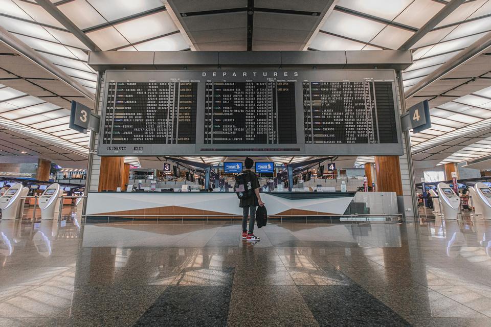 A departure hall with flight boards.