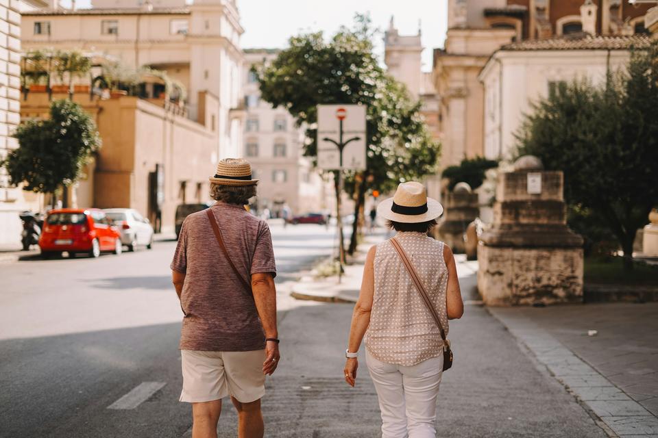 A couple walks through an old town.